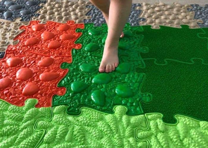 Kid steps on a Muffik sensory play mat