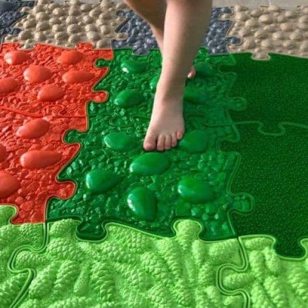 Kid steps on a Muffik sensory play mat