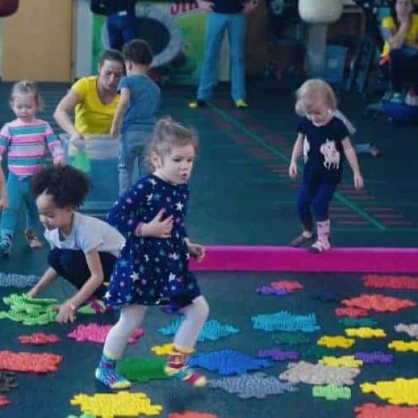 Happy children play on a sensory Muffik path during a session in a nursery